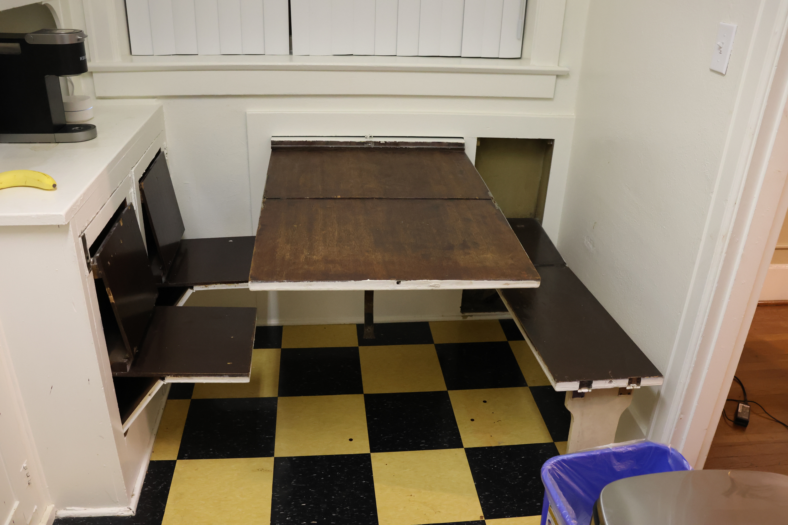 The odd cabinets in the previous photo fully opened. The tall narrow cabinet has unfolded into a bench. The large square cabinet has unfolded into a table. Two other cabinets on the left (which looked normal at first glance) have opened into chairs! All of it sags. It would obviously not be safe to use.